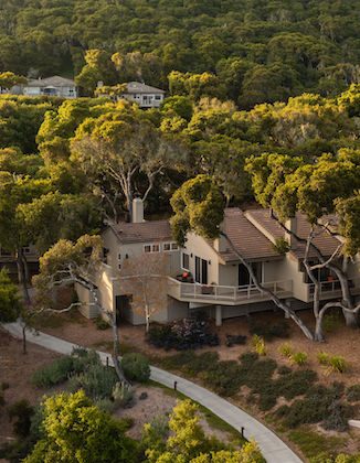view from above of a big cottage in the middle of green lavish trees at the Carmel Valley Ranch property