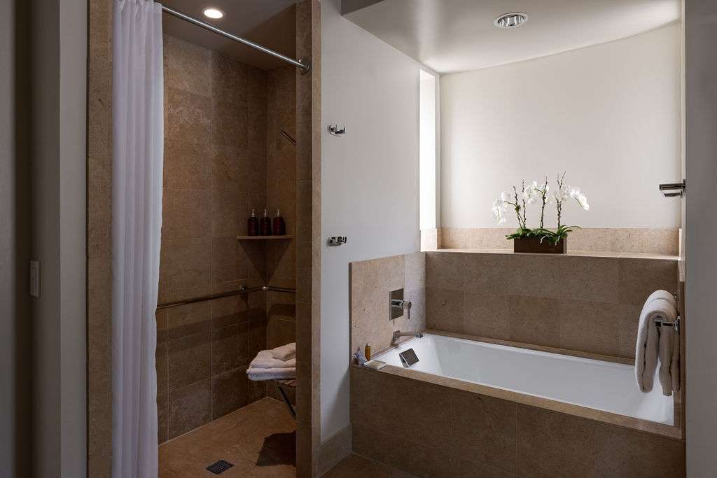 A hotel bathroom with tub and shower