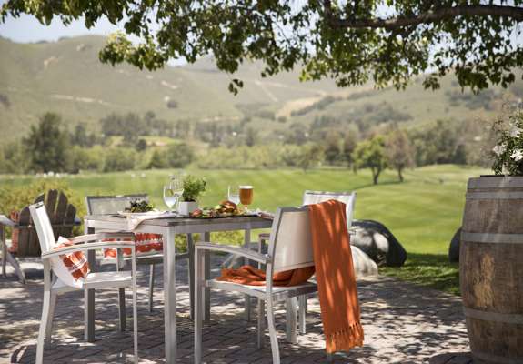 square table for four people beautifully setup for lunch at a garden overlooking the valley at Carmel Valley Ranch