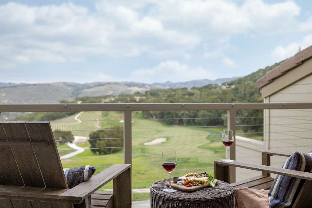 A balcony with two chairs and a view of Carmel Valley