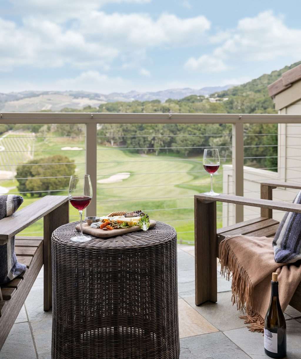 A balcony with two chairs and a view of Carmel Valley