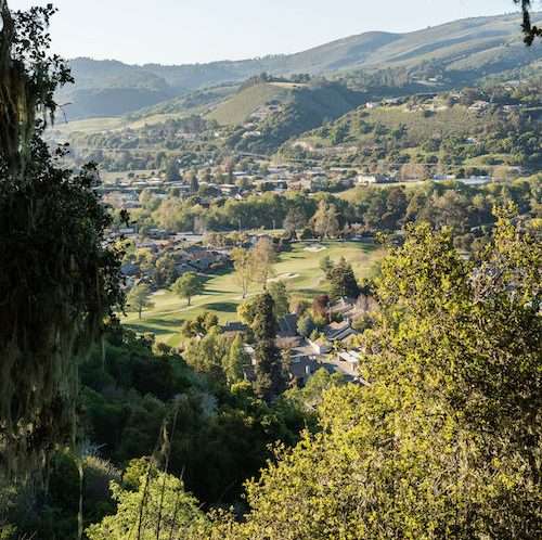 view of a Carmel Valley with Carmel Valley resort, green hills and trees all around