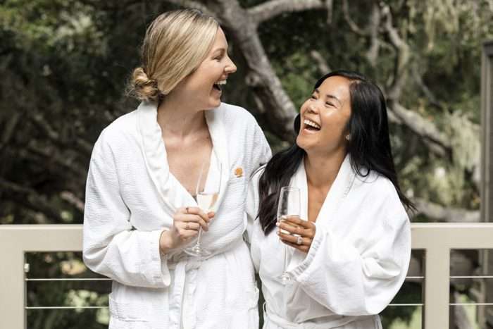 Two women enjoying champagne at spa Aiyana