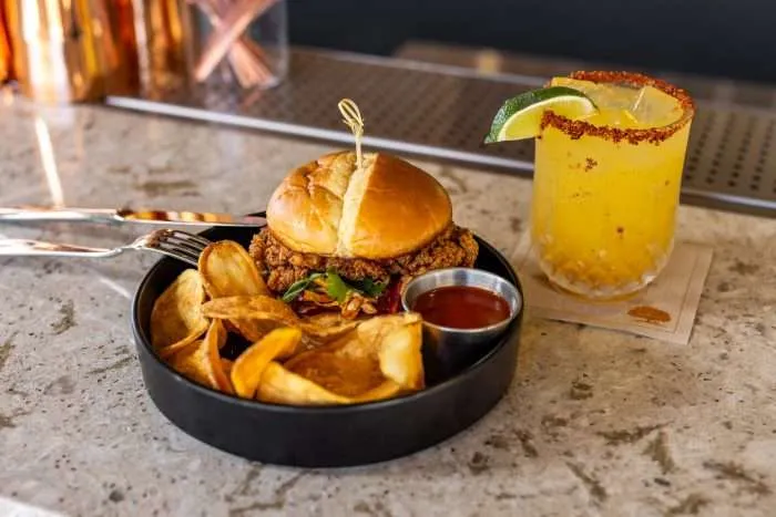 chicken sandwich and potato wedge plate with drink
